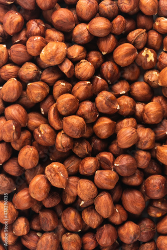 Peeled fresh golden hazelnuts close up in bulk top view