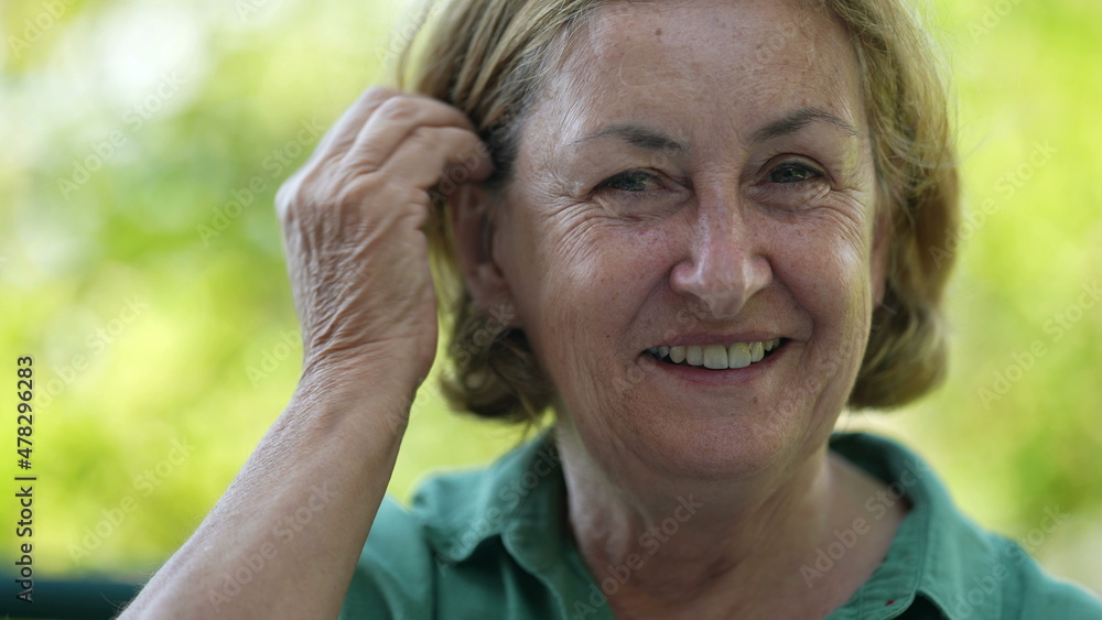 Happy senior woman in 60s smiling authentic laugh and smile Happy senior woman in 60s smiling authentic laugh and smile