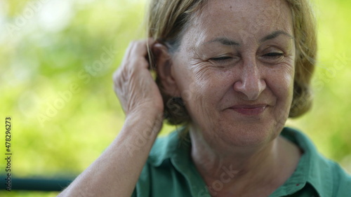 Happy senior woman in 60s smiling authentic laugh and smile