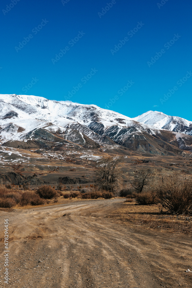 Fototapeta premium High cliffs in the mountains with snow on the peaks in Altai