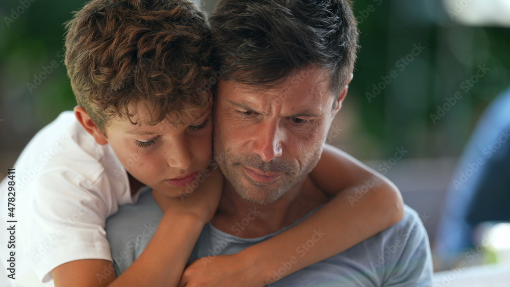 Candid father and child together, kid embracing dad