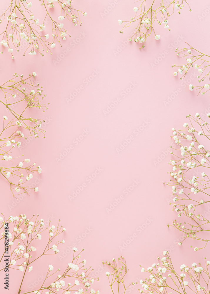 Creative pastel spring arrangement made of flowers on a pink background. Minimal floral concept with copy space. Wedding, Easter or Mother's Day inspiration.