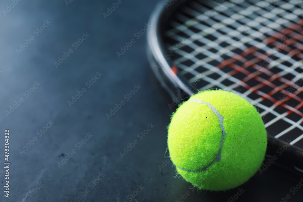 Sport and healthy lifestyle. Tennis. Yellow ball for tennis and a racket on the table. Sports background with tennis concept.