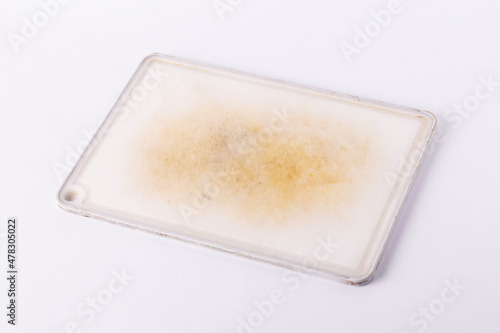 Old dirty kitchen board on a white isolated background.