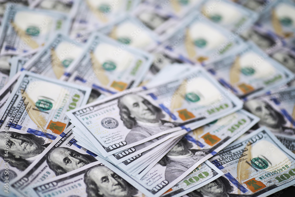 Group of money stack of 100 US dollars banknotes a lot of the background texture. Cash money in a large pile as a finance background. Group of money stack of 100 US dollars banknotes a lot of the background texture. Cash money in a large pile as a finance background.