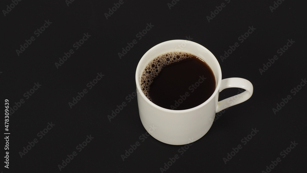 Hot coffee in white mug isolated on black background. Hot coffee in white mug isolated on black background.
