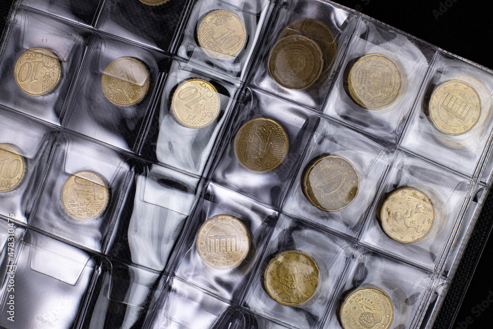Collection of European coins in a collectible case, selective focus, close-up, top view. Collection of European coins in a collectible case, selective focus, close-up, top view.