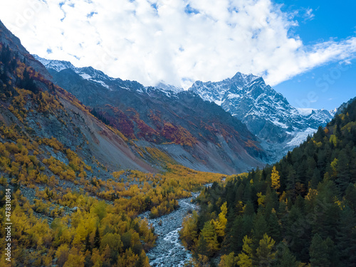 Beautiful, delightful autumn view from a drone of the mountains, the river, the Chalaadi glacier on a sunny day. Very beautiful autumn landscape of the mountains. Fabulous mountain autumn landscape photo