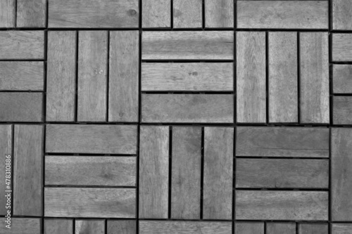 evocative black and white texture image of square shaped wooden dowels for flooring 