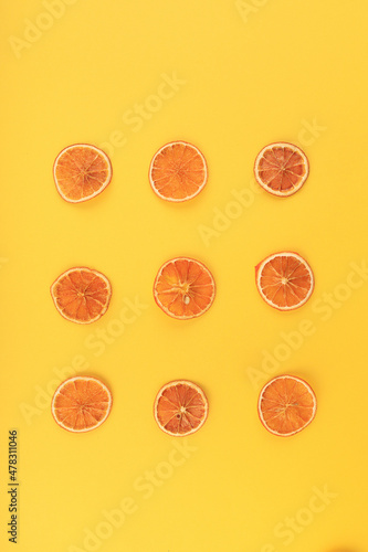 dried slised orange on a yellow background
