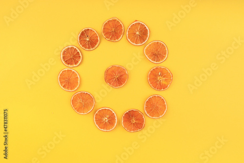 dried orange slices with a circle on a yellow background