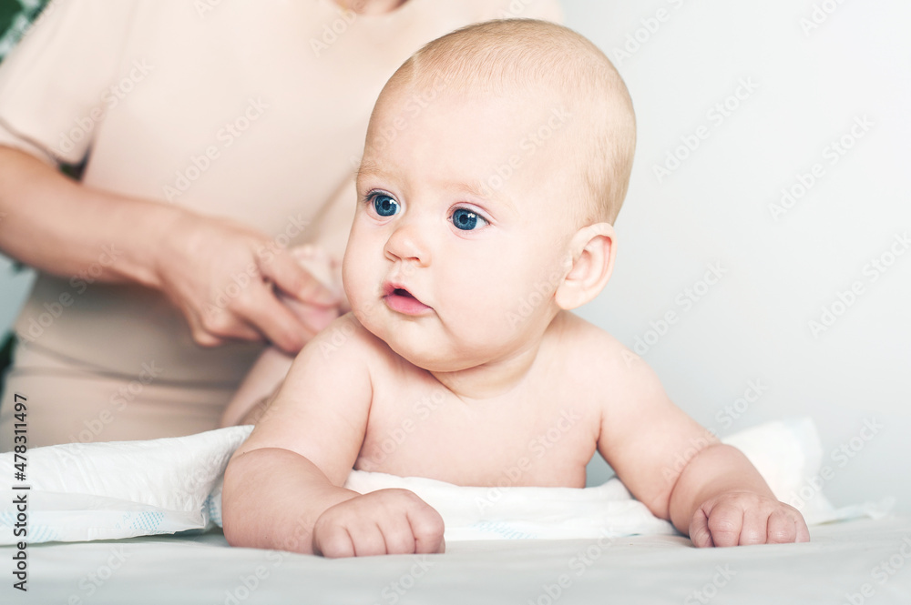 Newborn baby and mother's hands close up and copy space. Child 5 months old massage, colic, teething... Newborn baby and mother's hands close up and copy space. Child 5 months old massage, colic, teething...