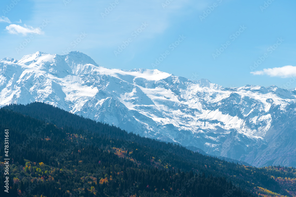 Beautiful mountain landscape, sunny autumn day with colorful trees and impressive snow peaks. Picturesque landscapes of the Caucasus mountains, Svaneti, Georgia
