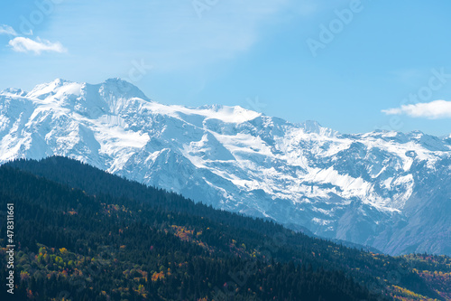 Beautiful mountain landscape, sunny autumn day with colorful trees and impressive snow peaks. Picturesque landscapes of the Caucasus mountains, Svaneti, Georgia