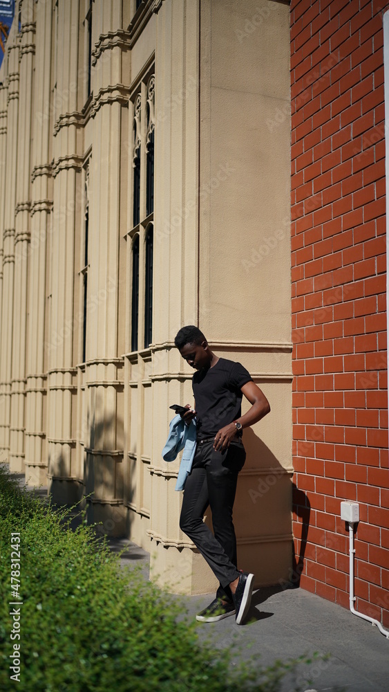Portrait of young attractive stylish african american man model posing in casual clothes against neutral background looking sexy with afro hair. In People Youth Beauty and fashion concept. Portrait of young attractive stylish african american man model posing in casual clothes against neutral background looking sexy with afro hair. In People Youth Beauty and fashion concept.