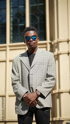 Portrait of young attractive stylish african american man model posing in casual clothes against neutral background looking sexy with afro hair. In People Youth Beauty and fashion concept.