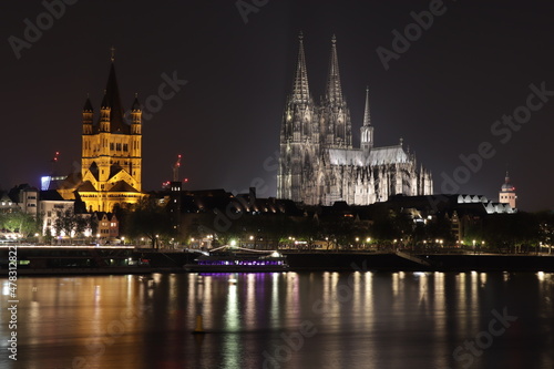 Cologne skyline with crane houses, dome and Rhine in the night