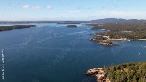 Beautiful harbor with many yachts. Cinematic aerial view to the rocky coastline Penobscot County, Maine, US. Panoramic drone footage. Flying over the harbor.  photo