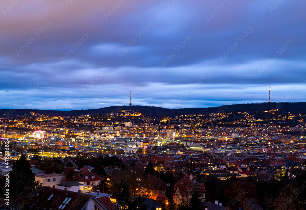 Stuttgart Cauldron nighttime panorama. Illuminated town at winter evening blue hour with hundreds of lights. Capital and largest city of the German state of Baden-Württemberg. Cradle of automobile. Stuttgart Cauldron nighttime panorama. Illuminated town at winter evening blue hour with hundreds of lights. Capital and largest city of the German state of Baden-Württemberg. Cradle of automobile.