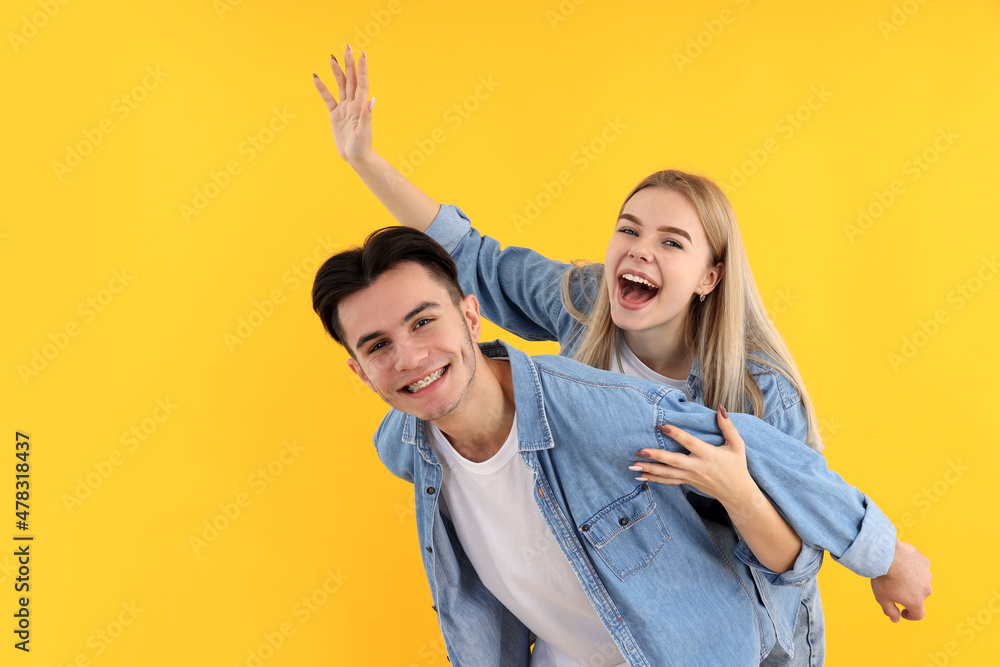 Cute and happy couple on yellow background Cute and happy couple on yellow background