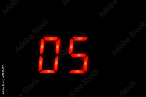 Old digital clock red number on black background