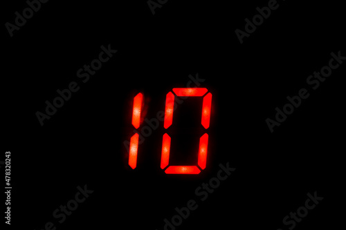 Old digital clock red number on black background