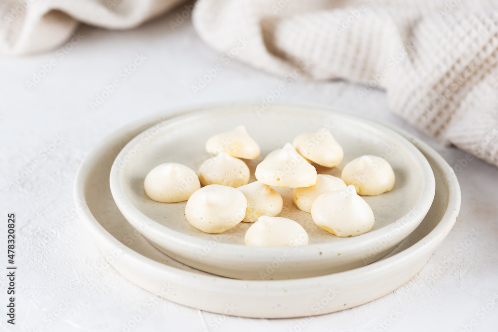 Homemade aquafaba meringue on a plate on the table. Sugar, lactose free, vegan dessert. Homemade aquafaba meringue on a plate on the table. Sugar, lactose free, vegan dessert.