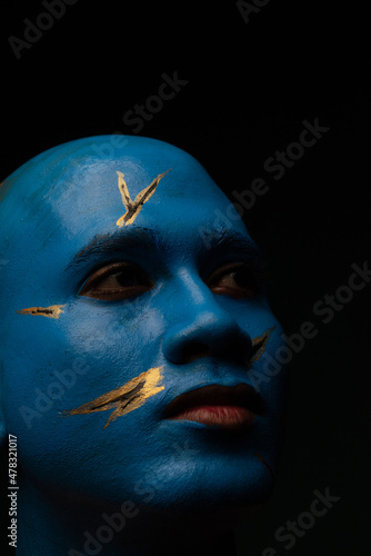 Bald man in blue makeup