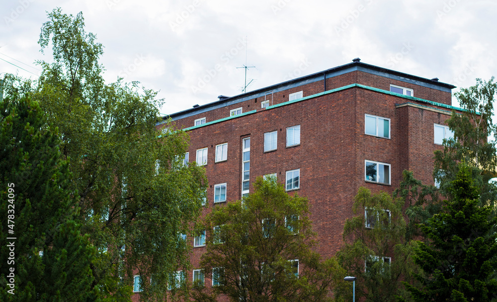 brick housing block at Majorstuen in Oslo, photographed from the nearby public park. Overcsast day.