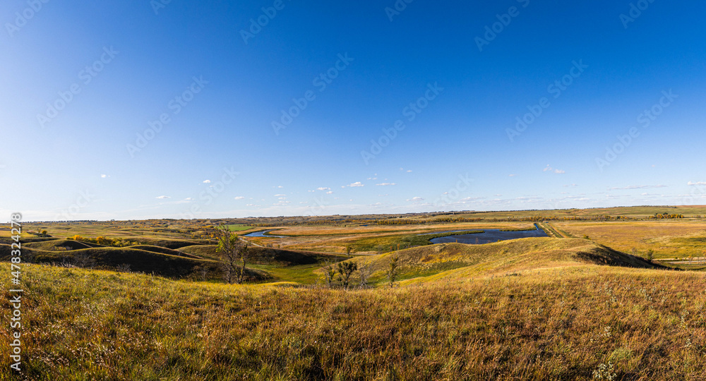 Panorama of the wide open prairie and grasslands in the American Midwest of North Dakota.  This is in the Upper Souris National Wildlife Refuge during the fall.
