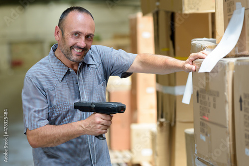 Canvas Print warehouse worker scanning barcode with handheld device