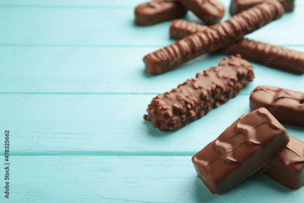Mix of chocolate bars on blue wooden background. Top view. Mix of chocolate bars on blue wooden background. Top view.