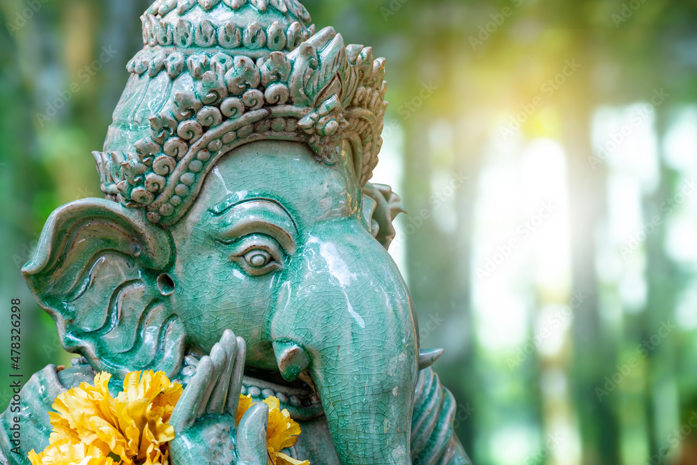green Ganesh elephant god statue close up focused on face green Ganesh elephant god statue close up focused on face