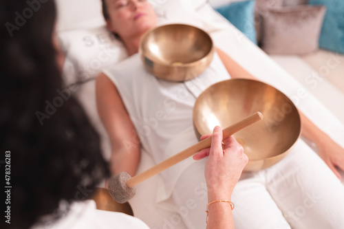 Singing bowls in sound healing therapy with two women