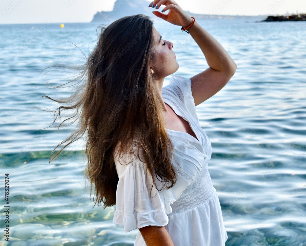 woman on the beach looking at the sea woman on the beach looking at the sea