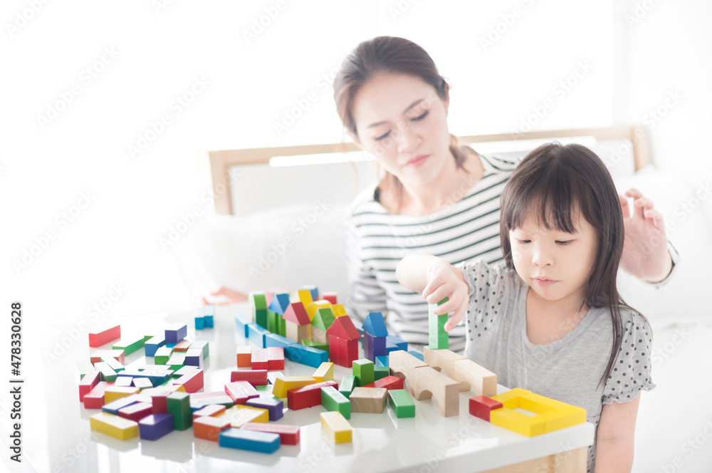 asian baby and her mother play puzzle wood toy, leaning and development asian baby and her mother play puzzle wood toy, leaning and development