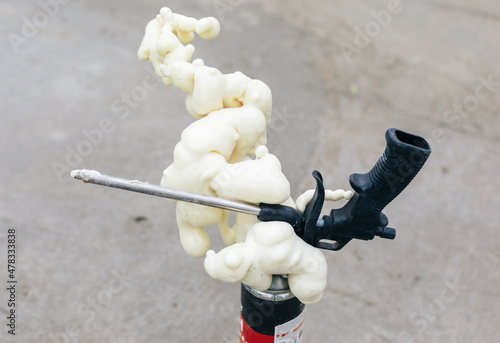 A gun for applying glue to foaming foam. Balloon foam. photo