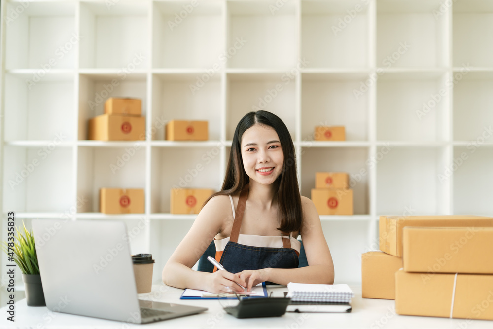 Young startup small business entrepreneur woman working with laptop at home, Online business, ecommerce and delivery concept Young startup small business entrepreneur woman working with laptop at home, Online business, ecommerce and delivery concept
