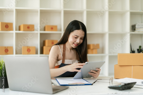 Small Business SME entrepreneur of Young Asian women working with tablet for Online shopping at home,Cheerful and Happy with box for packaging in home,Own Business Start up for Business Online © PaeGAG