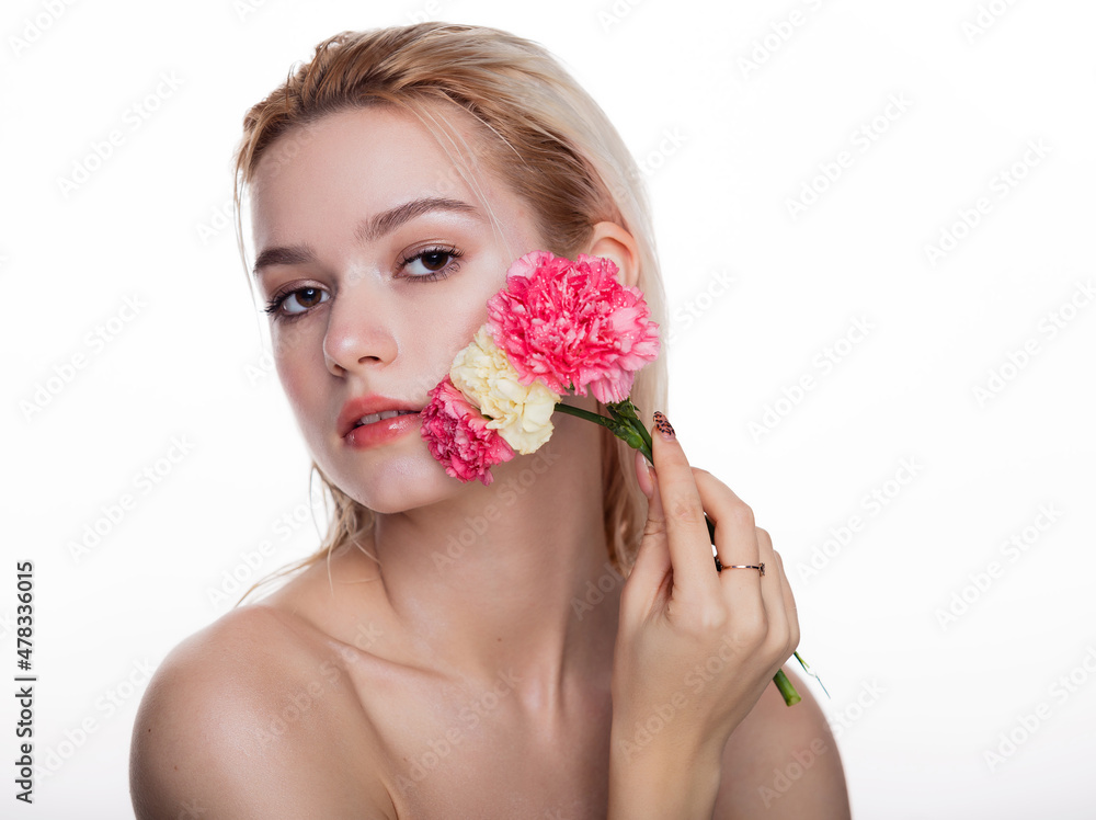 Charming young woman with pink flower. Blonde model holding pink flower close to face isolated over white background. Concept of beauty and health care free space for text Charming young woman with pink flower. Blonde model holding pink flower close to face isolated over white background. Concept of beauty and health care free space for text