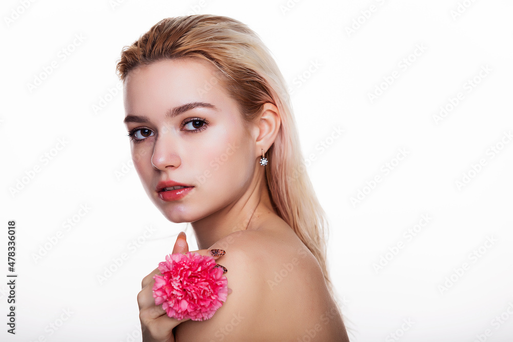 Charming young woman with pink flower. Blonde model holding pink flower close to face isolated over white background. Concept of beauty and health care free space for text Charming young woman with pink flower. Blonde model holding pink flower close to face isolated over white background. Concept of beauty and health care free space for text