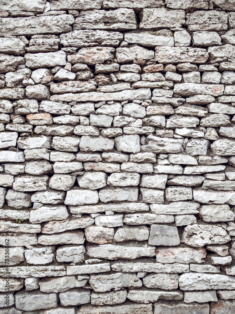 Texture of a antique stone wall. Old castle stone wall background
