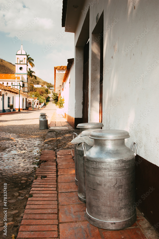 pitchers of milk at the door of a small town in the andes of Latin America pitchers of milk at the door of a small town in the andes of Latin America