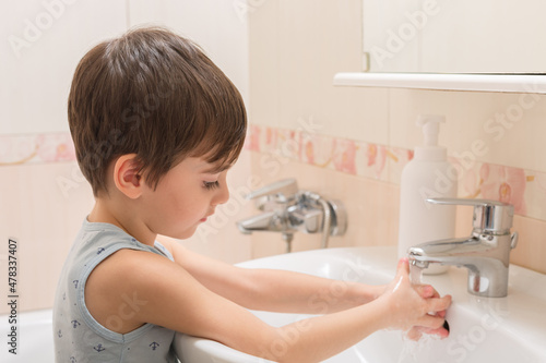 Wallpaper Mural A little boy washes his hands with soap and water in the sink. Torontodigital.ca