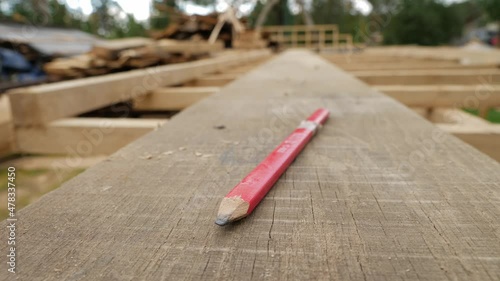 Carpenter's pencil on a woodlog, shalow depth of field. photo