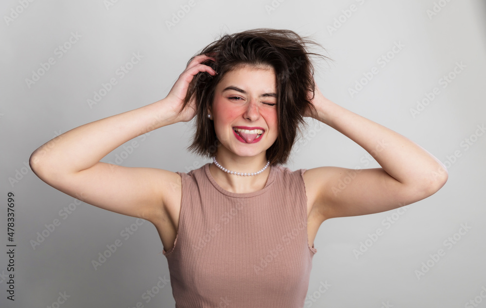 Fototapeta premium It's time to go to the beauty salon. Casual woman face expressions she does not go to spa, hair salon or beauty salon for long time. over gray background copy space.