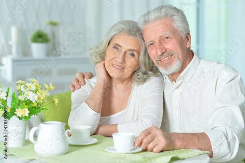 close up portrait of happy senior couple drinking tea
