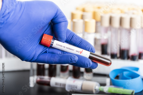 Doctor's hands hold blood samples of the new variant IHU, covid19, coronavirus. Selective approach to the sample tube. photo