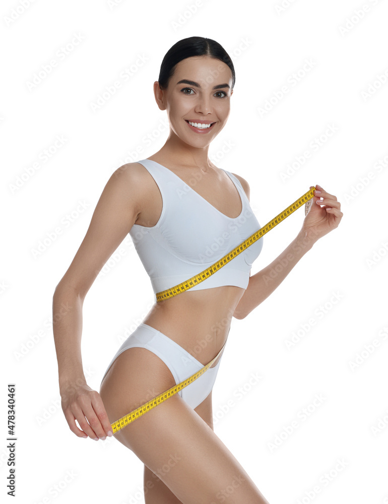 Young woman measuring waist with tape on white background Young woman measuring waist with tape on white background