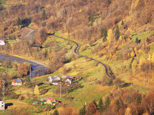 Carpatian village at mountains at the sunny day photo